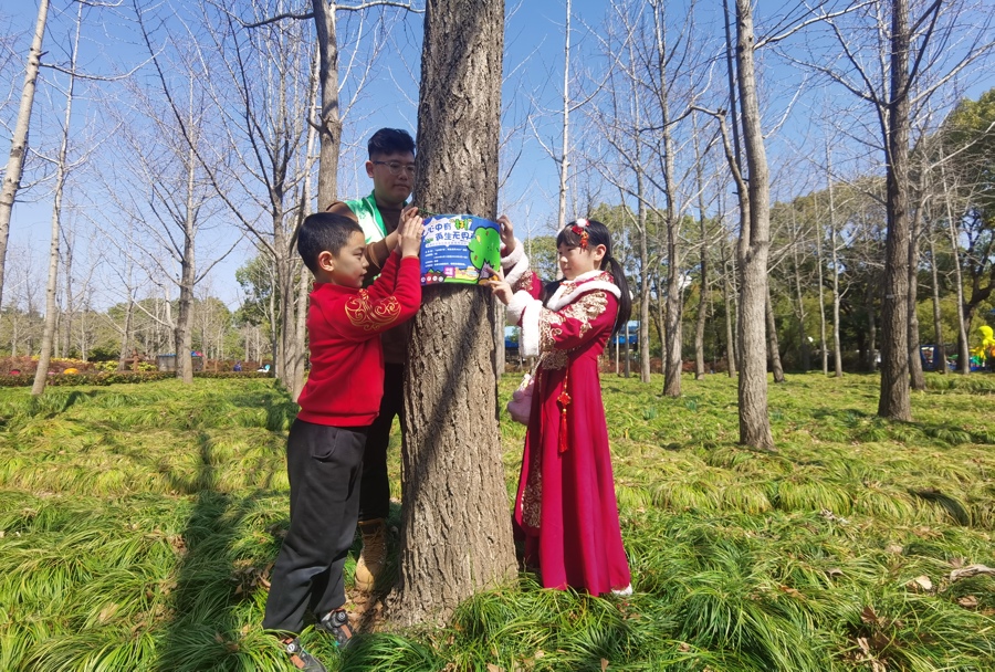 孩子们在志愿者协助下给认养的树木挂牌。 陈玺撼 摄.jpeg